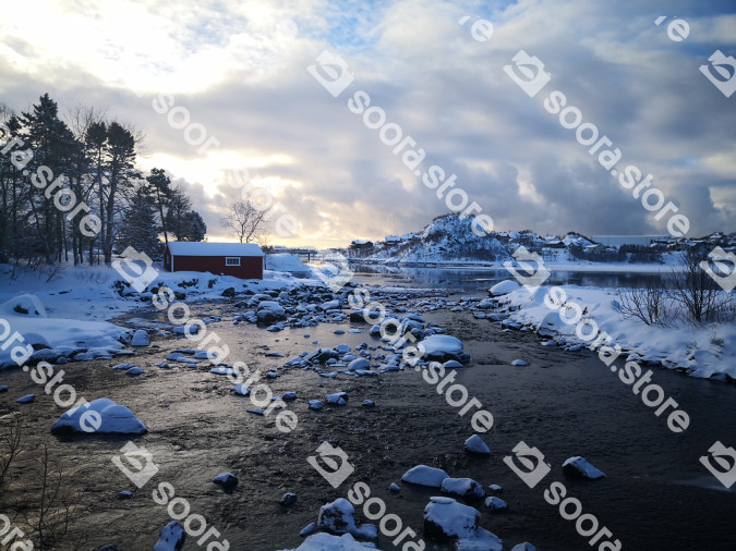 A Wooden Cabin Nestled Beside a Snowy Lake